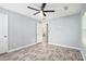Spacious bedroom with gray walls, modern ceiling fan, and wood floors at 248 Upshaw Sw St, Atlanta, GA 30315