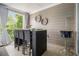 Stylish covered balcony with a bar table, chairs, and outdoor decor at 289 Heritage Se Ln, Atlanta, GA 30316