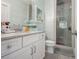 Bright bath featuring stylish vanity, shower, and coastal wallpaper at 289 Heritage Se Ln, Atlanta, GA 30316