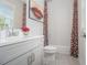 Stylish bathroom with artistic shower curtain, bright vanity, and sleek gray flooring at 289 Heritage Se Ln, Atlanta, GA 30316