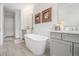 Elegant bathroom features a soaking tub, gray cabinets and upscale fixtures at 289 Heritage Se Ln, Atlanta, GA 30316