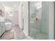 Well-lit bathroom features a frameless shower, gray tile and a soaking tub in the background at 289 Heritage Se Ln, Atlanta, GA 30316