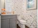 Stylish powder room features modern vanity, unique wallpaper, and contemporary fixtures at 289 Heritage Se Ln, Atlanta, GA 30316