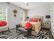 Comfortable bedroom with neutral walls, striking zebra rug, and bench at the foot of the bed at 289 Heritage Se Ln, Atlanta, GA 30316