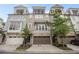 Attractive townhome exterior with an attached garage and small trees at 289 Heritage Se Ln, Atlanta, GA 30316