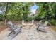 Backyard space featuring a stone fire pit circled by Adirondack chairs, set within a landscaped garden at 289 Heritage Se Ln, Atlanta, GA 30316