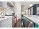 Spacious kitchen features stainless appliances, stone countertops, island with seating, and tile backsplash at 289 Heritage Se Ln, Atlanta, GA 30316