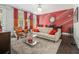 Open-concept living room with vibrant colors, a decorative rug, and large windows at 289 Heritage Se Ln, Atlanta, GA 30316