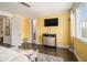 Spacious main bedroom with yellow walls, flat screen TV, and ensuite bath access at 289 Heritage Se Ln, Atlanta, GA 30316