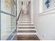 Bright stairway with hardwood steps, white risers, and a stylish glass-paneled door at 289 Heritage Se Ln, Atlanta, GA 30316
