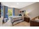 Well-lit bedroom featuring blue accents, a plush bed, and a large window view at 309 Elgin Dr # 155, Lawrenceville, GA 30045