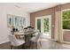 The dining room features a stylish table and chairs, artwork, and light-filled French doors at 309 Elgin Dr # 155, Lawrenceville, GA 30045