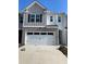 Charming two-story home with a two-car garage, brick accents, and modern architectural details at 309 Elgin Dr # 155, Lawrenceville, GA 30045