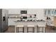Bright kitchen featuring white cabinetry, stainless steel appliances, and a granite countertop island with seating at 309 Elgin Dr # 155, Lawrenceville, GA 30045
