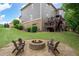 A spacious backyard with a stone patio, firepit, and an upper wooden deck at 3309 Nw Past Nw Pl, Kennesaw, GA 30152