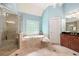Elegant bathroom featuring a separate shower and tub with tile surround and chandelier at 3309 Nw Past Nw Pl, Kennesaw, GA 30152