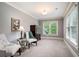Bright bedroom with sitting area, neutral walls, and natural light streaming through the window at 3309 Nw Past Nw Pl, Kennesaw, GA 30152