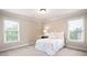 Comfortable bedroom with natural light from two windows and neutral decor to create a peaceful retreat at 3309 Nw Past Nw Pl, Kennesaw, GA 30152