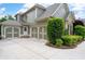 Charming home with a three-car garage, stone accents, well-maintained landscaping, and a spacious driveway at 3309 Nw Past Nw Pl, Kennesaw, GA 30152