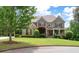 Inviting two-story home with stone accents, lush landscaping, and a well-manicured front lawn at 3309 Nw Past Nw Pl, Kennesaw, GA 30152