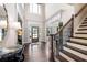 Elegant foyer with hardwood floors, a staircase, and a view into the dining and living areas at 3309 Nw Past Nw Pl, Kennesaw, GA 30152