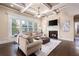 A living room with a fireplace, coffered ceiling, and large windows at 3309 Nw Past Nw Pl, Kennesaw, GA 30152