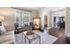 Bright living room with large windows, neutral decor, and an open layout to the dining area at 3309 Nw Past Nw Pl, Kennesaw, GA 30152