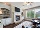 Bright living room with stone fireplace, built-in shelving, and hardwood floors; perfect for relaxing at 3309 Nw Past Nw Pl, Kennesaw, GA 30152