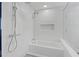 Elegant white tiled bathroom with dual shower heads and a sleek, modern design aesthetic at 346 Peters Sw St # 207, Atlanta, GA 30313