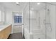 Bright bathroom featuring glass enclosed tub/shower, neutral colors and modern vanity at 346 Peters Sw St # 207, Atlanta, GA 30313