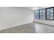Bedroom with large window allowing natural light and concrete floors at 346 Peters Sw St # 207, Atlanta, GA 30313