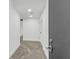 Hallway with white walls, concrete floor, and a door on the right at 346 Peters Sw St # 207, Atlanta, GA 30313
