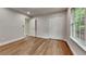 This bedroom features hardwood floors, a large closet, and neutral paint throughout at 3681 Auger Trl, Douglasville, GA 30135