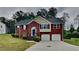 Charming two-story brick home with attached two-car garage and well-manicured front lawn at 3681 Auger Trl, Douglasville, GA 30135