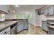 This kitchen features modern appliances, tile floors and granite counters at 3681 Auger Trl, Douglasville, GA 30135