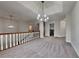 Spacious living room with a modern chandelier, fresh grey carpet and neutral paint at 3681 Auger Trl, Douglasville, GA 30135