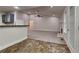 Open concept living room and kitchen featuring tile floors, fireplace, and neutral colors at 3681 Auger Trl, Douglasville, GA 30135