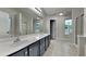 This main bathroom has dual sinks, tile floor and a glass enclosed shower at 3681 Auger Trl, Douglasville, GA 30135