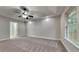 Large main bedroom featuring fresh carpet, neutral paint, a ceiling fan and natural light at 3681 Auger Trl, Douglasville, GA 30135