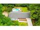 Expansive aerial view of home, showcasing pool, manicured lawn, mature trees, and traditional architectural style at 1662 Rainier Falls Ne Dr, Atlanta, GA 30329