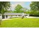 Charming home featuring a pool, patio and well-manicured lawn at 1662 Rainier Falls Ne Dr, Atlanta, GA 30329