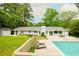 Inviting backyard with pool, patio, and lush landscaping creating a private oasis at 1662 Rainier Falls Ne Dr, Atlanta, GA 30329