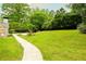Expansive green lawn and walkway highlight the outdoor space of the home at 1662 Rainier Falls Ne Dr, Atlanta, GA 30329