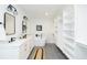 Spacious bathroom featuring double sinks, modern fixtures, soaking tub, and a large walk-in closet at 1662 Rainier Falls Ne Dr, Atlanta, GA 30329
