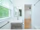 Updated bathroom with gray vanity, new faucet, tile shower, and view to next room at 1662 Rainier Falls Ne Dr, Atlanta, GA 30329