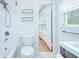 Updated bathroom with gray vanity, new faucet, tile shower, and view to next room at 1662 Rainier Falls Ne Dr, Atlanta, GA 30329