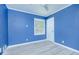 Blue bedroom has a window, white door, wood-look floors and white trim at 1662 Rainier Falls Ne Dr, Atlanta, GA 30329