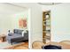 A dining room featuring a grey sofa and a wooden shelf at 1662 Rainier Falls Ne Dr, Atlanta, GA 30329