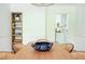 A dining room featuring a wooden table and six chairs with a bookshelf on the side at 1662 Rainier Falls Ne Dr, Atlanta, GA 30329