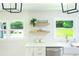 Bright kitchen featuring stainless steel appliances, a farmhouse sink, and floating shelves for storage at 1662 Rainier Falls Ne Dr, Atlanta, GA 30329